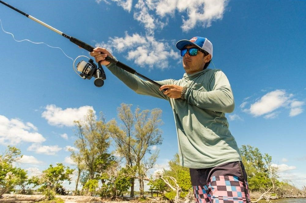 Man fishing with Pursuit IV Spinning Combo